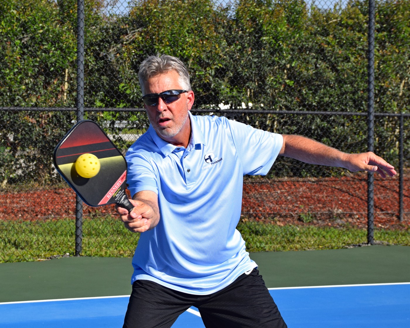 Steve Kennedy hitting a forehand, ball on the paddle